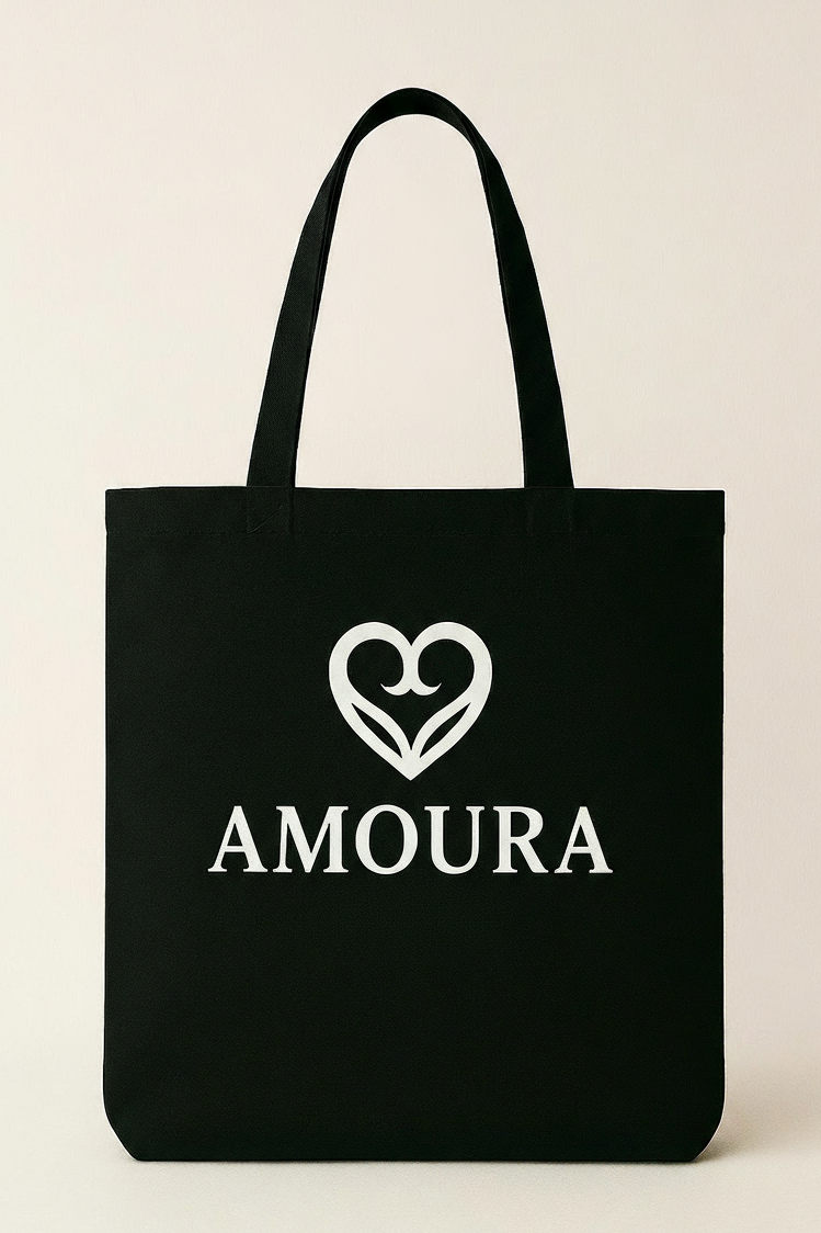 Black tote bag with 'AMOURA' logo on a beige background